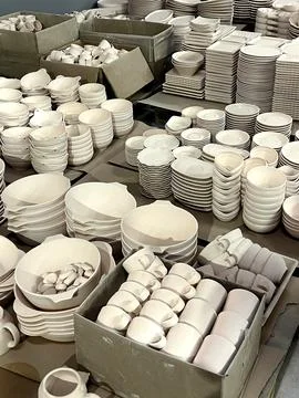 Clay is shaped into various ceramic items and organized in boxes, waiting for Stock Photos