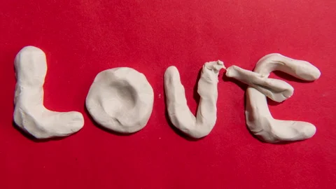 Clay stop-motion of a heart-shaped turn into the word “love” Stock Footage 317737352