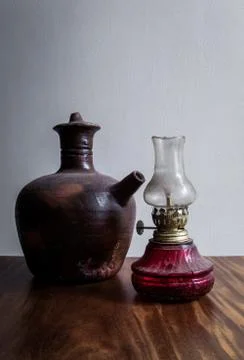 Clay water jug and traditional oil lamp Stock Photos