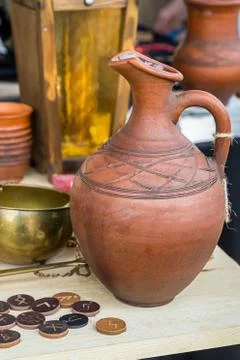 Clay wine jug geometric pattern stack of coins medallions runic pattern label Stock Photos