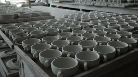 Clay workshop. Blanks of tea cups stand on wooden trays. Panorama. Close up. Video stock 130526264