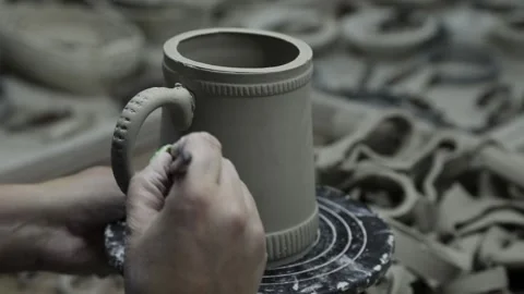 Clay workshop. The brush covers the joints of the handle of the clay mug. Video stock 130526314