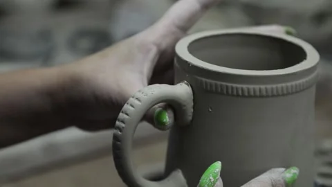 Clay workshop. Gluing the handle to the clay mug. Grayscale. Video stock 130526285