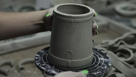 Clay workshop. The master glues the handle to the clay mug. Grayscale Video stock 130526340
