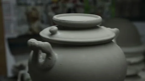 Clay workshop. An unpainted clay samovar turns on a stand. Grayscale. Video stock 130526280