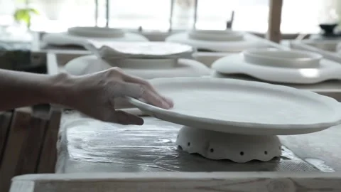 Clay workshop. A womans hand rubs the bottom of the vase stand. Close up. Video stock 130526257