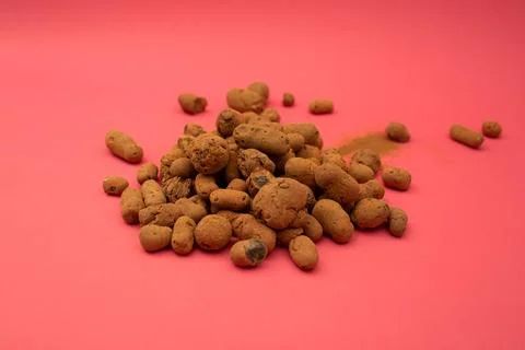 Claydite scattered on a bright background Stock Photos