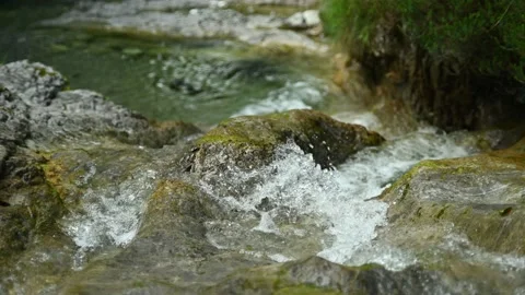 Clean and clear water flows over rocks into a pool Stock-Footage 211472597