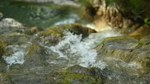 Clean and drinkable water flows over rocks into a pool Stock Footage 211472461