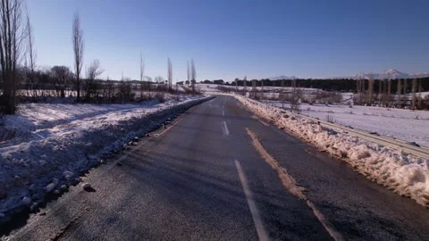 Clean and empty road on snow covered vast fiels, jk01 Stock Footage 267740590