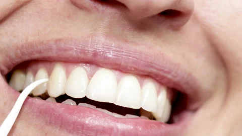 Clean and floss space between teeth with plastic toothpick Stock Footage 191034851