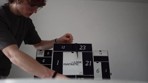 A clean and focused moment of discovering a surprise from the advent calendar. T Stock Footage 301106832