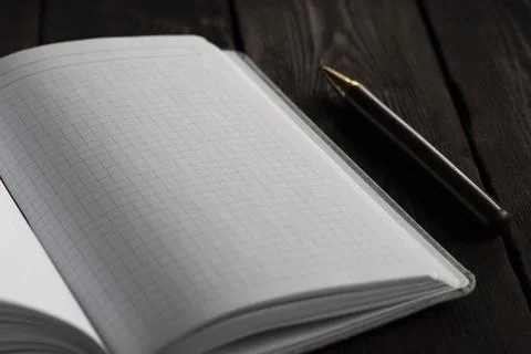Clean and minimal close-up of an open grid-page notebook Stock Photos