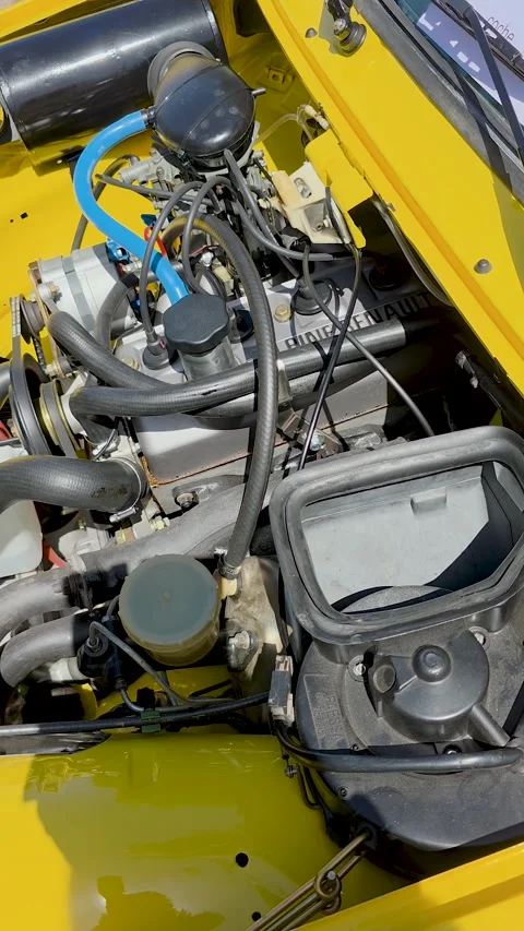Clean and restored classic car engine bay of a yellow vintage Renault 5 auto Stock Footage 337589687