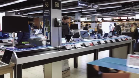 Clean and tidy tech store with shoppers looking at products Stock Footage 136204334