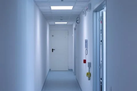A clean and white corridor is seen inside a science laboratory with room for  Stock Photos