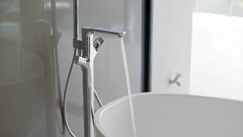 Clean bathroom with refreshing shower, reflecting mirror, and sleek tiles. Stock Footage 247925801