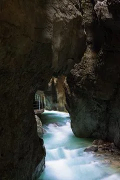 Clean, beautiful, mountain river flows through a rocky grot Partnachklamm i.. Stock Photos