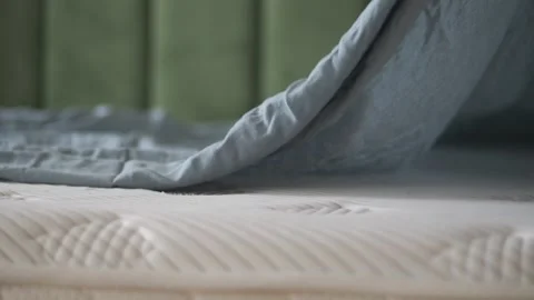 Clean bedding on a mattress in a bedroom setting Stock Footage 323150105