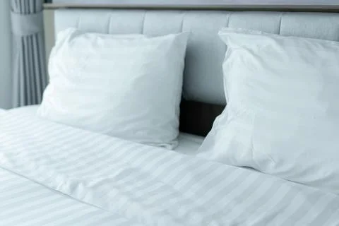 Clean Bedding sheets and pillow at hotel for traveler Stock Photos