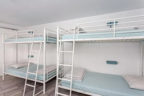 Clean bedroom with bunk beds in a hotel, a hostel for tourists. Stock Photos