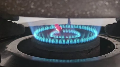 A clean blue flame burning brightly on a modern gas stove burner Stock Footage 335112488