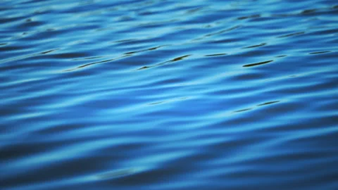 Clean blue water waves moving softly, calming nature footage in cinematic 4K Stock Footage 326831673