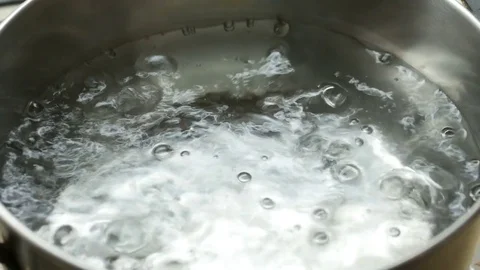 Clean boiling water in a pan, close-up Stock Footage 82314528