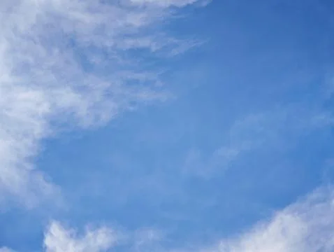 Clean bright blue sky background with light wispy clouds for presentation d.. Stock Photos