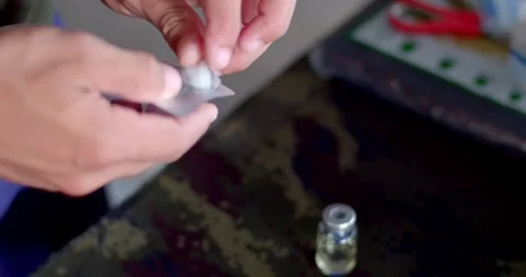 Clean the cap of the medicine bottle before inserting the needle. Stock Footage 252249202
