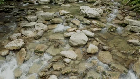 Clean clear cold water flowing through the stones of the rocks. Stock Footage 169876867