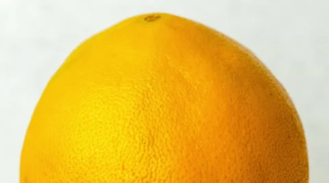 Clean clear water streaming down over orange fruit with vibrant citrus skin,  Stock Footage 62759932