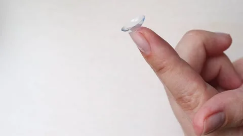 Clean closeup of innovative breathable moisturizing contact lens balanced on Stock Footage 309310440