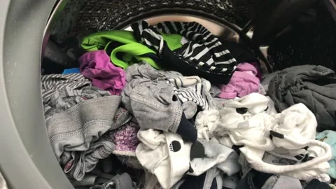 Clean colored laundry in the washing machine. Open door on the washing machine. Stock Footage 132636510