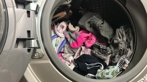 Clean colored laundry in the washing machine. Open door on the washing machine. Stock Footage 132636530