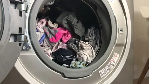 Clean colored laundry in the washing machine. Open door on the washing machine. Stock Footage 132636549