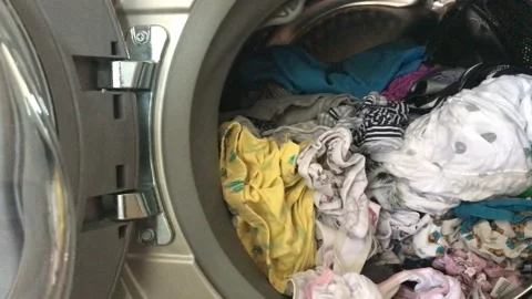 Clean colored laundry in the washing machine. Open door on the washing machine. Stock Footage 132636627