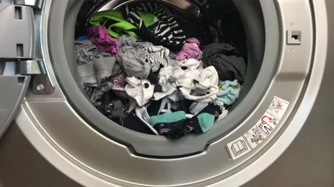 Clean colored laundry in the washing machine. Open door on the washing machine. Stock Footage 132874768