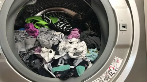 Clean colored laundry in the washing machine. Open door on the washing machine. Stock Footage 132874832