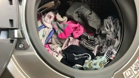 Clean colored laundry in the washing machine. Open door on the washing machine. Stock Footage 132874975