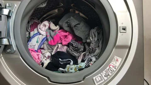 Clean colored laundry in the washing machine. Open door on the washing machine. Stock Footage 132875034