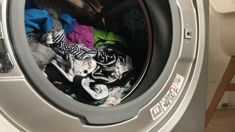 Clean colored laundry in the washing machine. Open door on the washing machine. Stock Footage 132875222