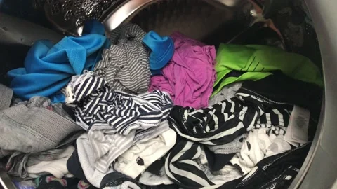 Clean colored laundry in the washing machine. Open door on the washing machine. Stock Footage 132875293