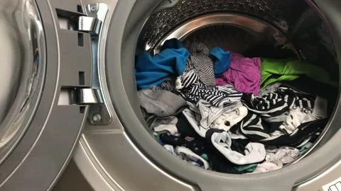 Clean colored laundry in the washing machine. Open door on the washing machine. Stock Footage 132875386