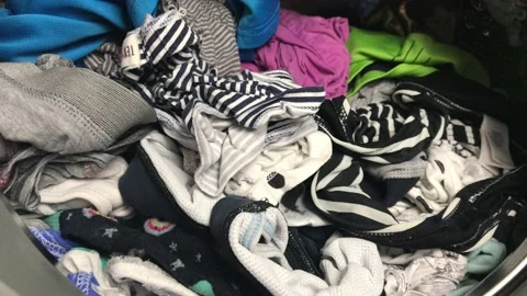 Clean colored laundry in the washing machine. Open door on the washing machine. Stock Footage 132875417