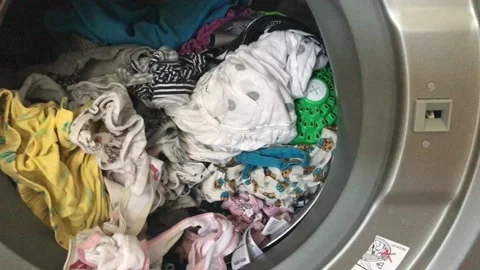 Clean colored laundry in the washing machine. Open door on the washing machine. Stock Footage 132875499