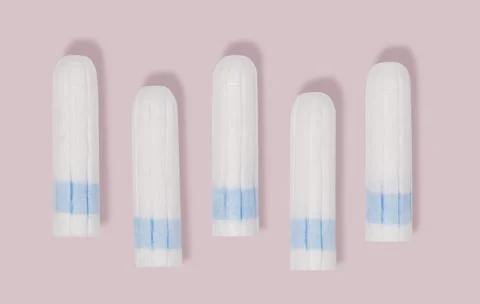 Clean cotton tampons with blue string on pink background Stock Photos