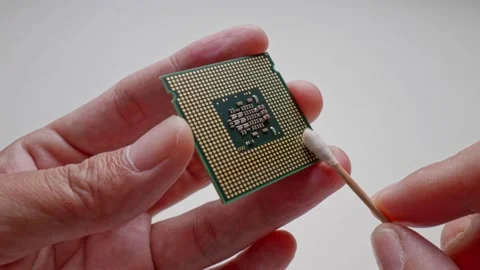Clean the CPU contacts by wiping them clean with a cotton pad moistened with Stock-Footage 188426550