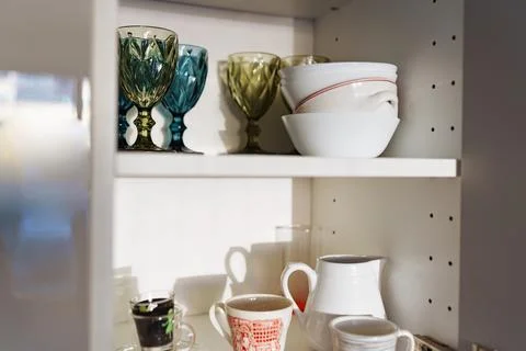 Clean dishes and tableware on white shelf 스톡 사진