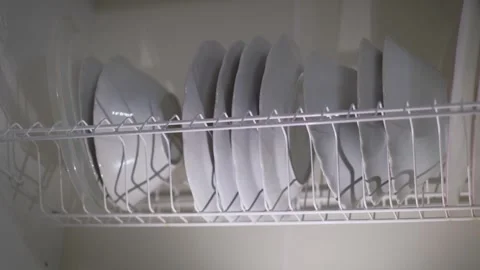 Clean dishes in the cupboard for drying and storage, close-up Stock Footage 301649568